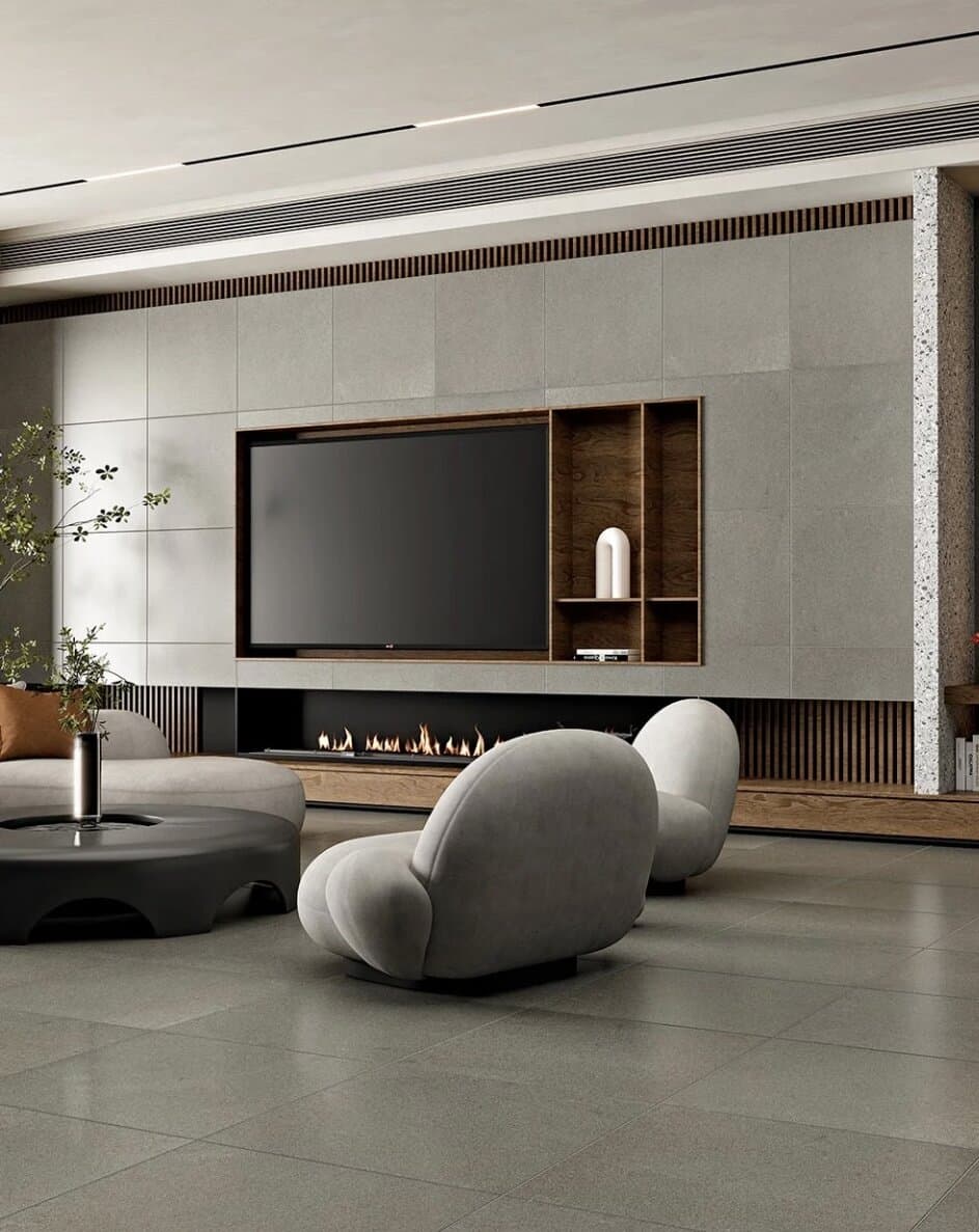 Brushed grey stone tile flooring in a modern living room with a built-in fireplace media wall