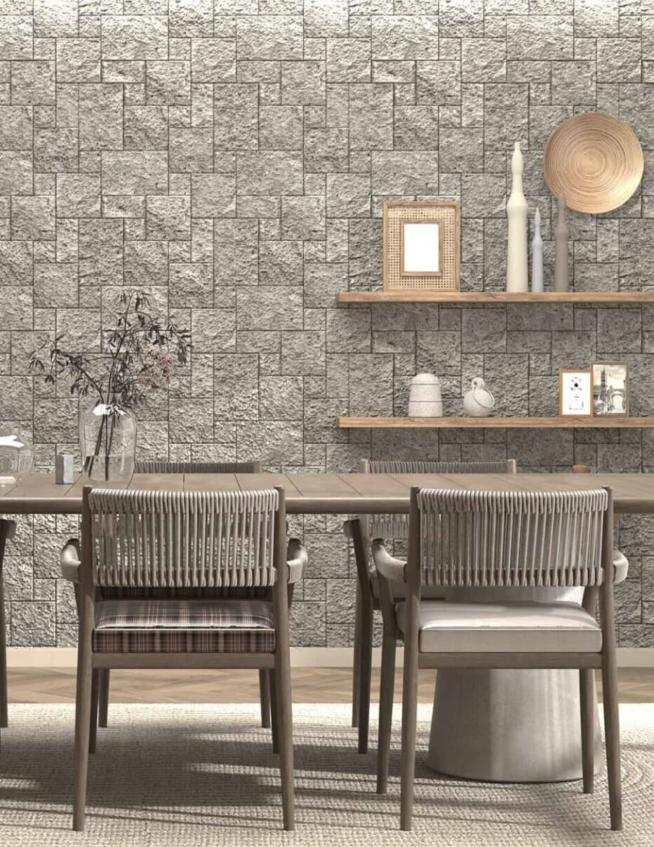 Textured split-face stone cladding used as a feature wall behind a dining area