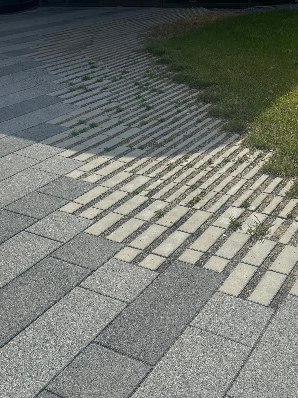 Basalt paving tiles installed along a storefront entrance