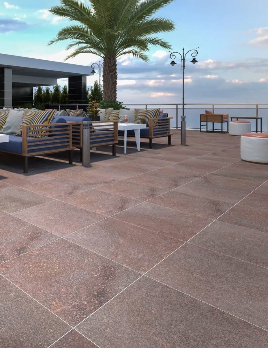 Bronze-toned stone paving on a rooftop terrace lounge area